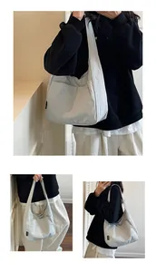 Detail of light gray tote bag with pleated texture and minimal brand tag for daily use