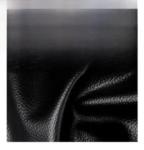 Macro shot of durable oil-wax leather texture with litchi grain and glossy finish