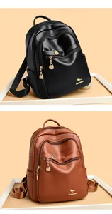 Detail of black and brown leather backpacks showing litchi texture and metal kangaroo logo