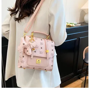 Detailed close-up of textured pink crossbody bag with NX monogram and pony charm