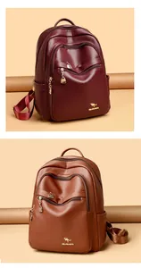 Detail of leather backpacks in burgundy and brown with textured finish and metal logo