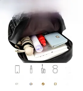 Detail view of the spacious black pebbled leather backpack showing organized interior storage