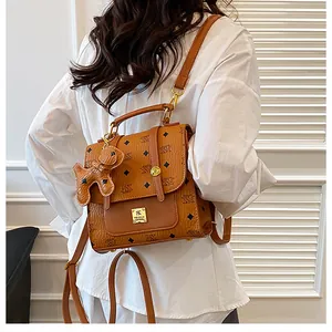 Detailed back view of a brown monogram backpack with cute animal charm and gold hardware