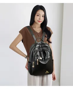 Close-up of litchi grain leather backpack with golden zippers and kangaroo logo detail
