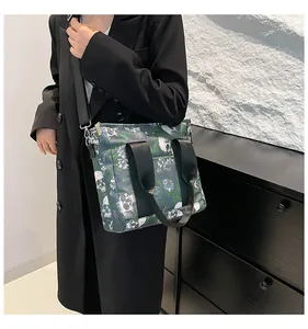 Detail der Reisetasche mit Totenkopfmuster, verstärkten Griffen und Schultergurt