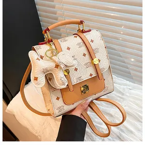 Detailed close-up of a printed backpack showing luxury leather texture and gold buckle