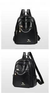 Detail view of black lychee grain leather backpack with golden zippers and kangaroo logo
