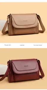 Close-up of premium cowhide leather texture and side pocket detail on the shoulder bag