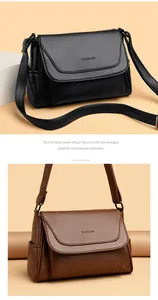 Detail view of black and brown crossbody bags featuring premium lychee texture leather