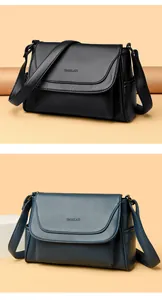 Close-up of litchi texture leather handbags in black and navy with adjustable straps