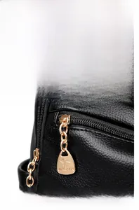 Detail of black pebbled leather texture and premium gold kangaroo logo on women backpack