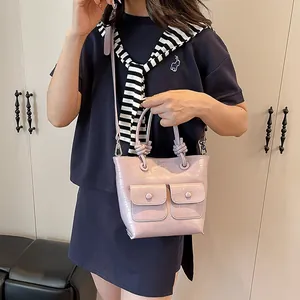 Lavender crocodile embossed handbag with knot handle and dual front pockets