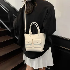 White crocodile pattern handbag with double front pockets and adjustable shoulder strap