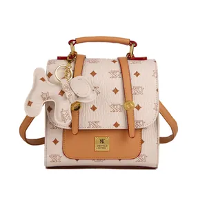 Minimalist beige and brown printed backpack for women with a cute dog-shaped charm