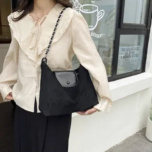 Chic black suede shoulder bag with chain strap and smooth leather flap for commute