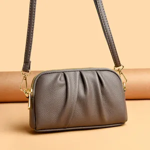 Fashionable taupe genuine leather crossbody bag with pleated texture and gold hardware
