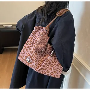 Dettaglio della borsa tote in tela leopardata rosa con stampa gatto e borsa piccola