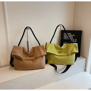 Detail of canvas tote bags with unique braided handles in brown and lime green colors