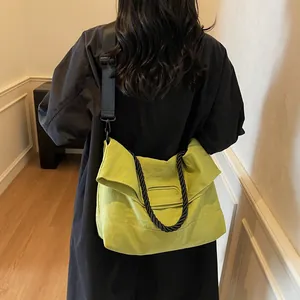 Bright green minimalist tote bag with braided handle and adjustable shoulder strap