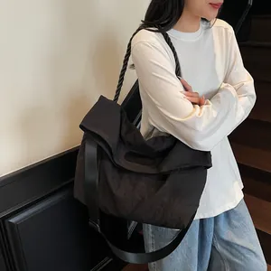 Minimalist large black tote bag with dual straps for stylish daily commuting and shoulder use