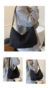 Detail view of large black tote bag featuring nylon fabric and adjustable strap
