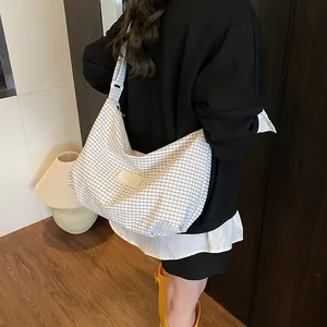 Large Korean-style plaid tote bag with wide shoulder strap shown in a home setting