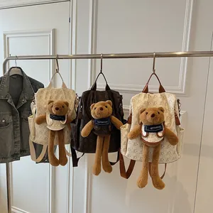 Fashionable large capacity backpack with teddy bear doll and repeating bear pattern