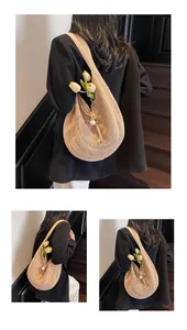 Detailed view of beige woven hobo shoulder bag featuring elegant large pearl closure