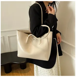 Detail of minimalist tote bag with glossy pleated texture and shoulder straps