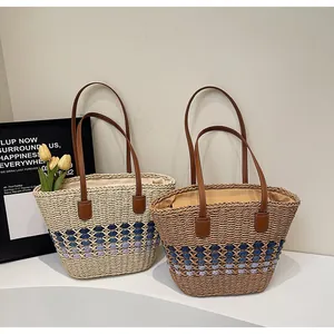 Detail of handmade woven straw tote bags with leather handles and diamond patterns