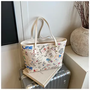Detail view of large tote bag with colorful graffiti prints and sturdy shoulder straps