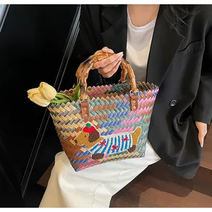 Detail of handmade woven tote bag with cartoon dog patch and bamboo style handles
