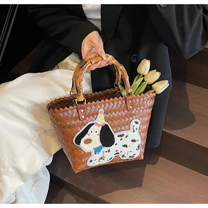 Detail of woven tote bag with a bamboo handle and a cute dachshund towel embroidery patch