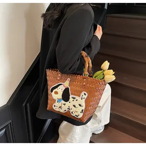 Detailed texture of brown woven tote bag with bamboo handle and cute dog patch
