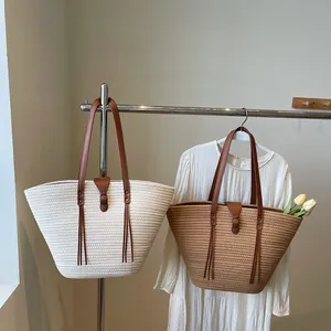 Large woven tote bags in cream and brown with leather straps and fringe detail