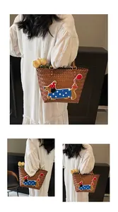 Brown woven tote bag featuring a cute dachshund puppy embroidery detail with party hat