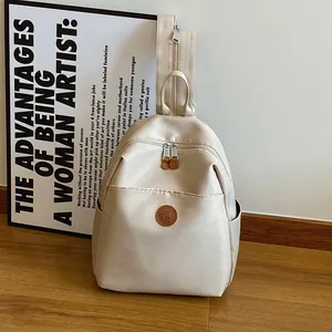 Minimalist nylon backpack for women in beige with dual zippers and artistic lifestyle vibe