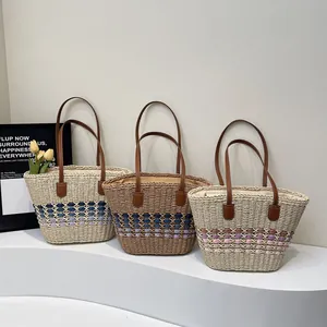 Handmade woven straw tote bags with leather handles in three striped color variations