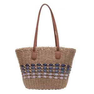 Handmade straw tote bag with blue gradient weave and brown leather shoulder straps