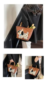 Detailed view of woven tote with bamboo handle, spotted dog patch and tulip decoration