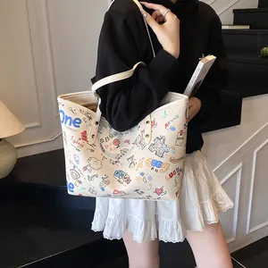 Large beige graffiti tote bag with colorful artistic prints and shoulder straps