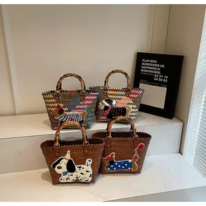 Detail of four handmade woven tote bags with dachshund embroidery and bamboo handles