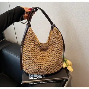 Macro view of woven straw tote bag texture and premium brown leather shoulder strap
