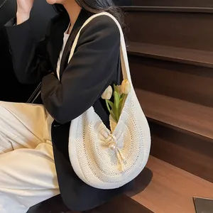 Large capacity beige straw woven shoulder bag with pearl clasp and semi-moon shape design