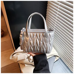 Detail of silver quilted texture and sparkling rhinestones on an elegant crossbody bag