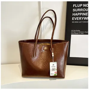 Detail of retro dark brown tote bag showing textured faux leather and kangaroo logo print