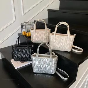 Quilted crossbody bags with glitter diamonds in black, silver, cream, and gold colors