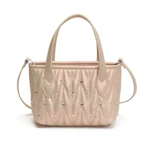 Quilted champagne pearlescent handbag with vertical wave texture and rhinestone accents