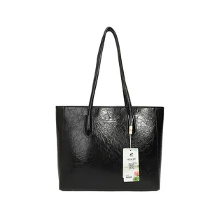Minimalist large black tote bag for women with polished faux leather and kangaroo logo