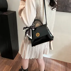 Vintage black faux leather shoulder bag with decorative fashion scarf and gold metal clasp